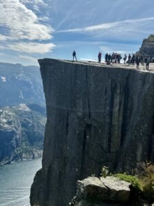 Sherry on a windswept ridge above a Norwegian fjord